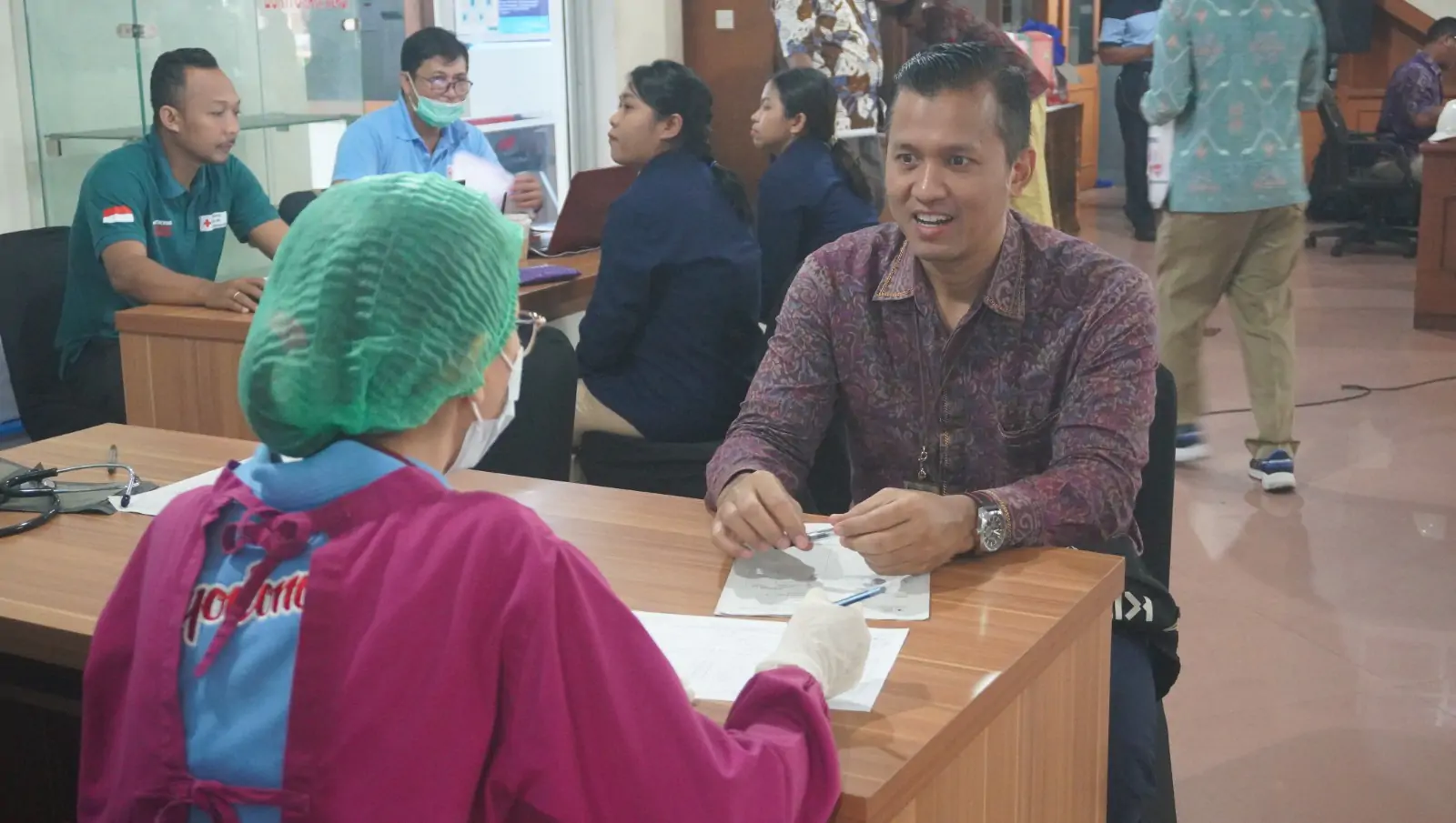 GM PT PLN (Persero) UID Bali, Eric Rossi Priyo Nugroho sedang dilakukan pengecekan kesehatan oleh tim medis dari PMI sebelum pengambilan darah dilaksanakan.
